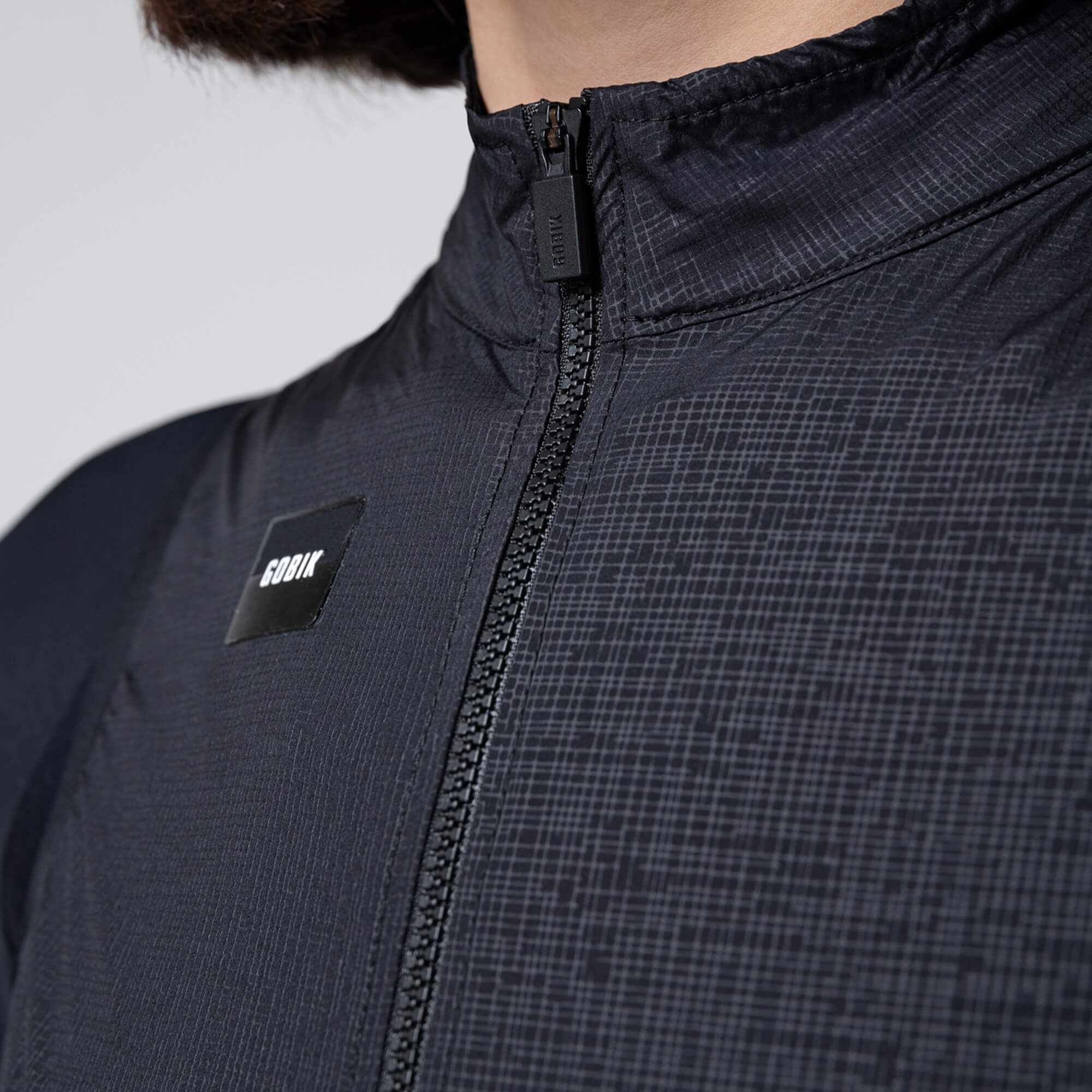 Close-up of GOBIK Vector 2.0 Vest - Women's showing front zipper and textured black fabric with logo patch