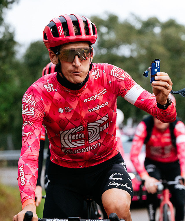 Fast Bar Chocolate | 12 pack shown in gallery position 2 with portrait view, cyclist holding an energy bar outdoors