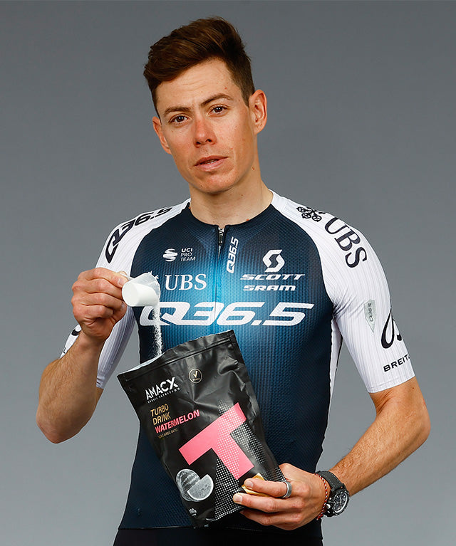 Athlete holding Turbo Drink Watermelon powder pouch and scooping serving, gallery position 2, portrait 640x767 pixels