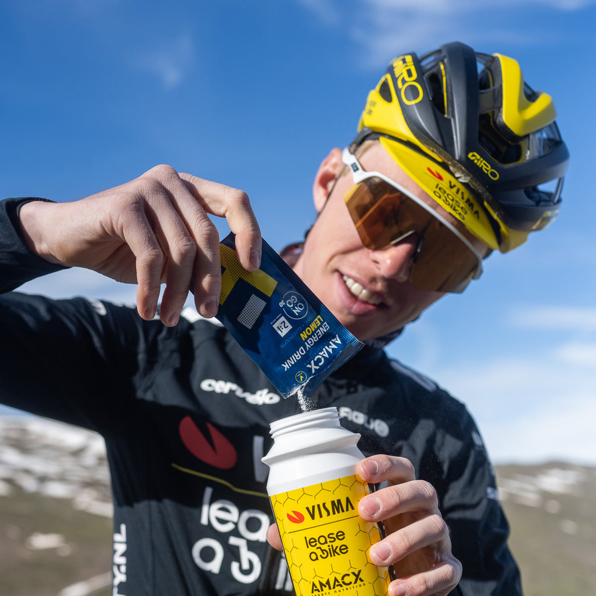 Cyclist pouring Energy Drink On The Go | 12 pack into bottle outdoors, gallery position 4, 1200x1200 square image