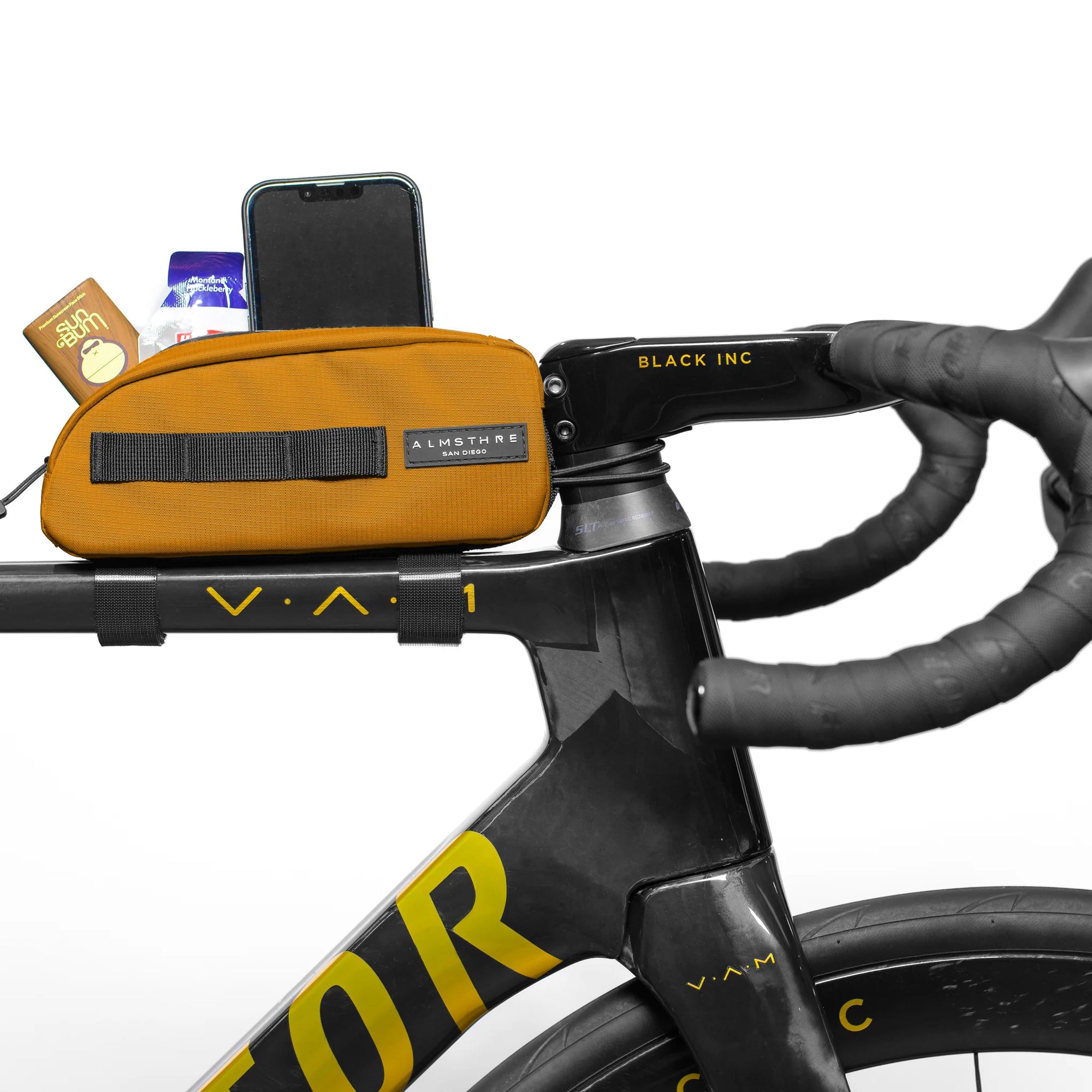 ALMSTHRE Top Tube Bag mounted on bike frame with snacks and phone showing easy-access storage solution