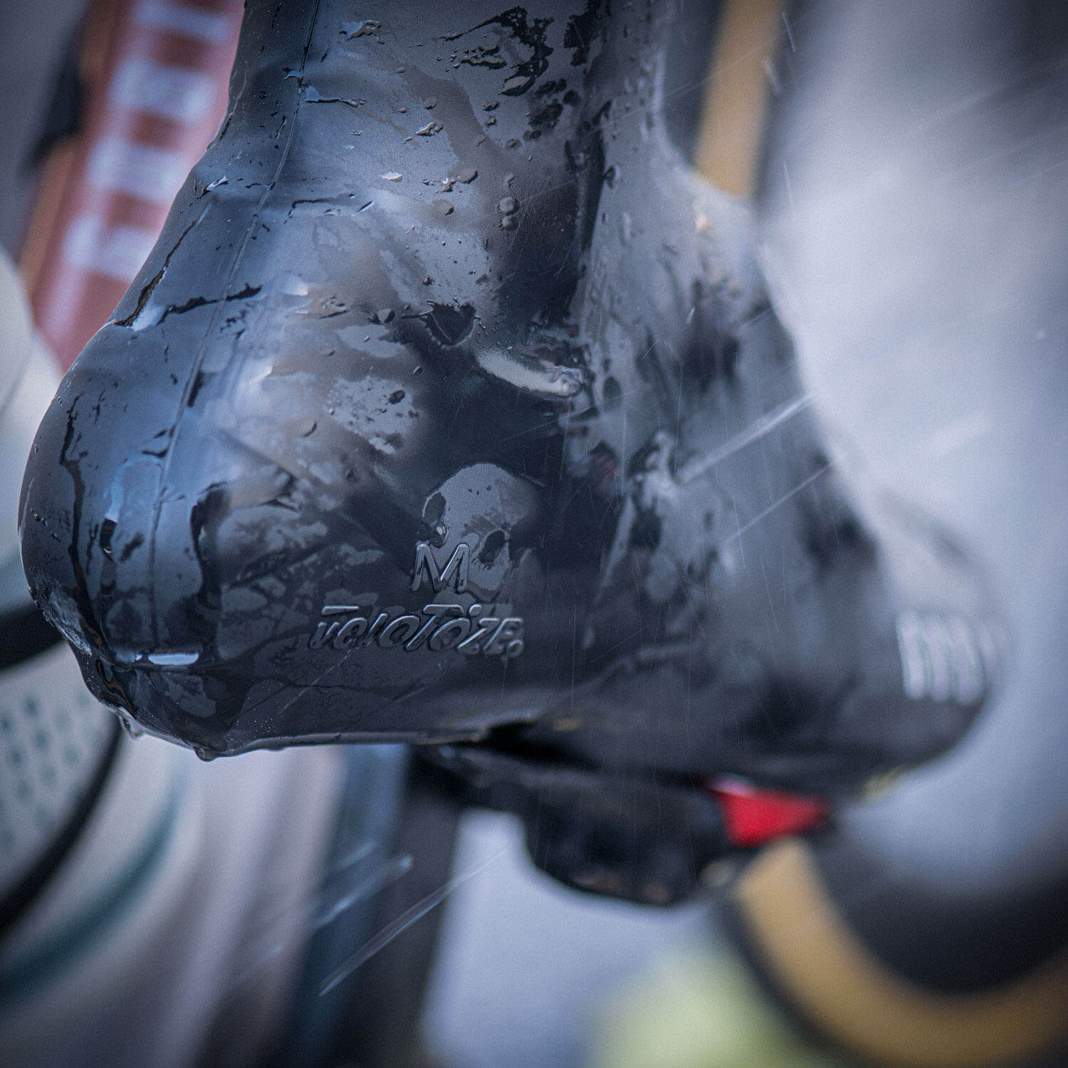 Close-up of a wet cycling shoe covered by GOBIK VELOTOZE Snaps Tall Overshoes - Unisex with water-resistant material