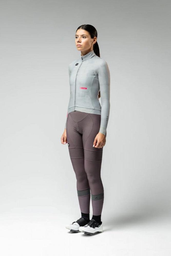 Woman wearing GOBIK Hyder Long Sleeve Jersey - Women's in light gray with fitted design and high collar against plain background