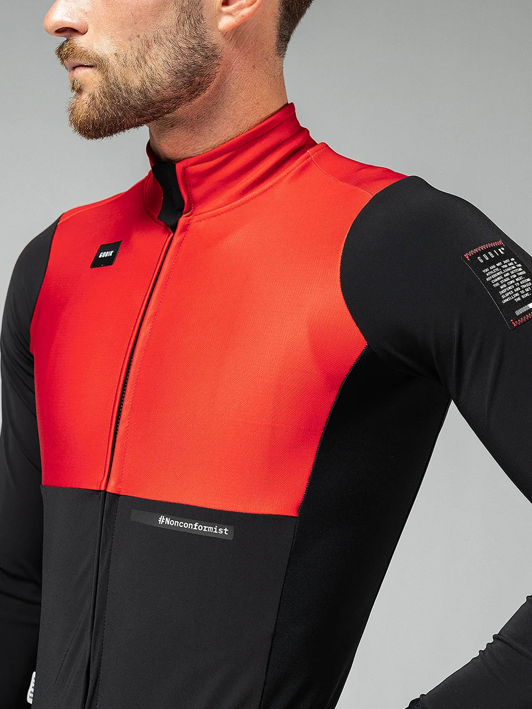 Close-up of man wearing GOBIK Mist Blend 2.0 Jacket - Men's with red and black wind-resistant cycling design