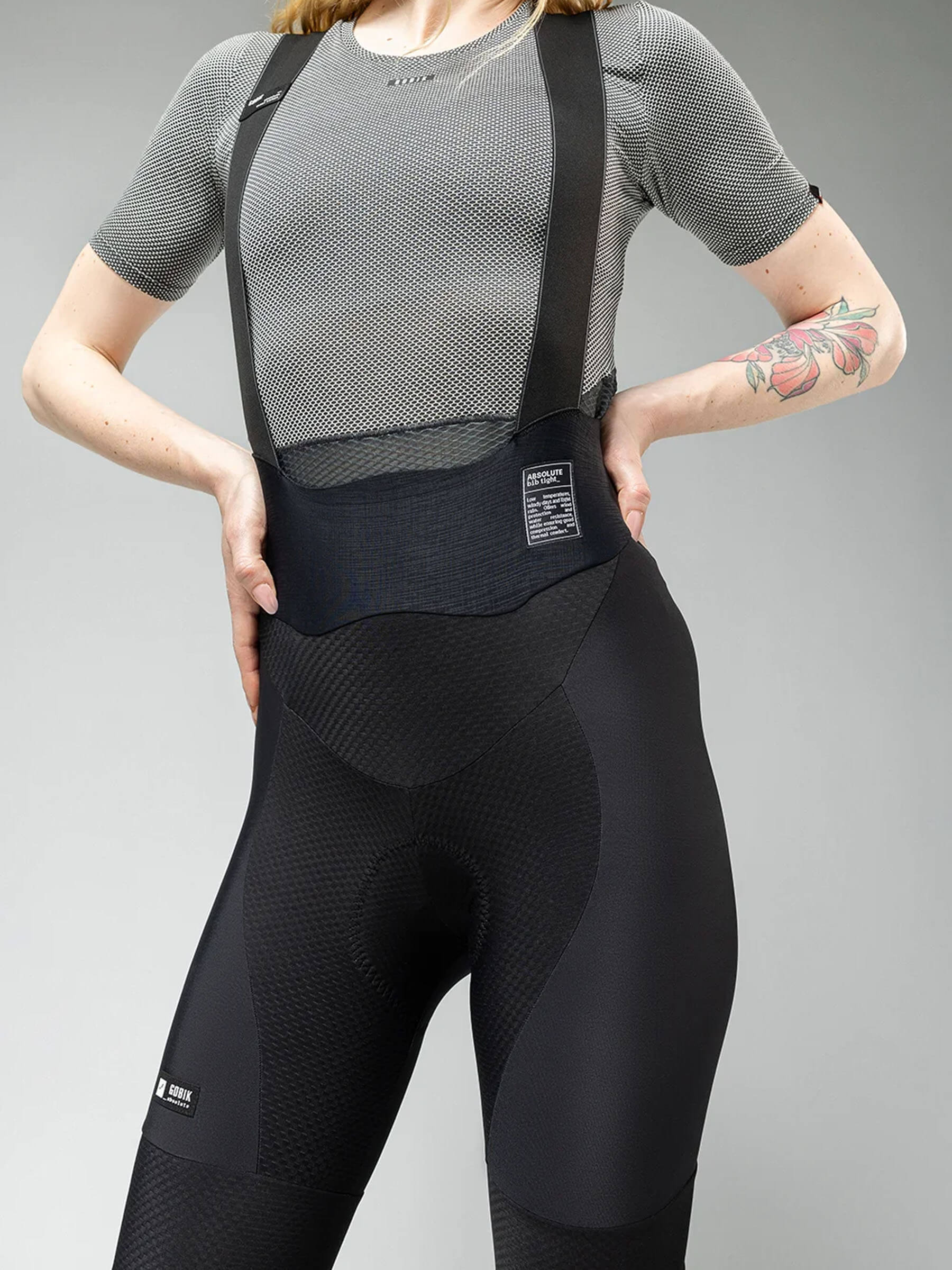Woman wearing GOBIK Absolute 6.0 K9 Bib Tights - Women's in black with supportive bib straps and textured fabric panels