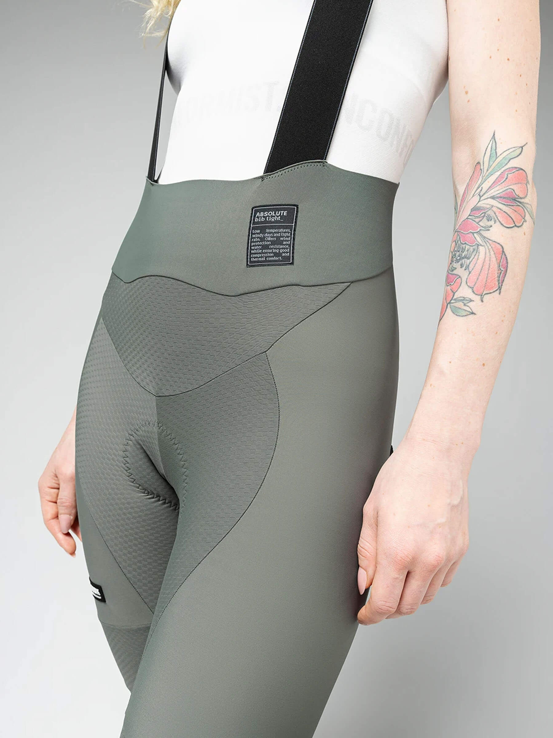Close-up of woman wearing GOBIK Absolute 6.0 K9 Bib Tights - Women's in muted green with padded seat and elastic waistband