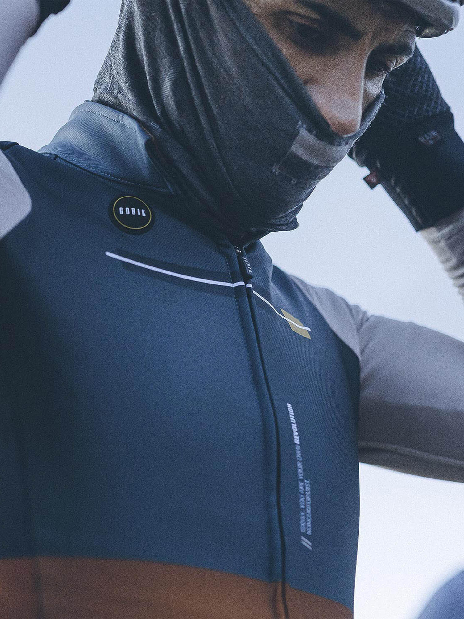 Man wearing GOBIK Moonbah Merino Neck Warmer, lightweight and ergonomic for cool weather cycling comfort.