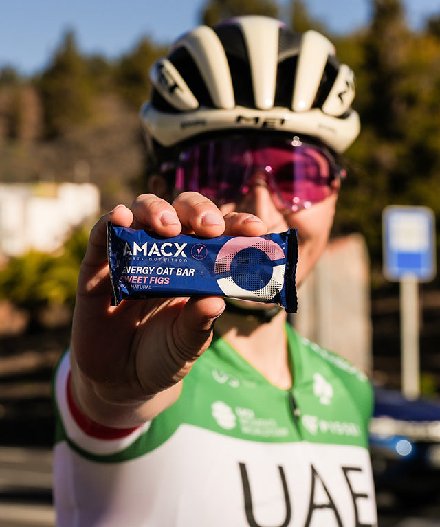 Person in cycling gear holding Energy Oat Bar Sweet Figs | 12 pack close-up gallery position 2 portrait 640x767