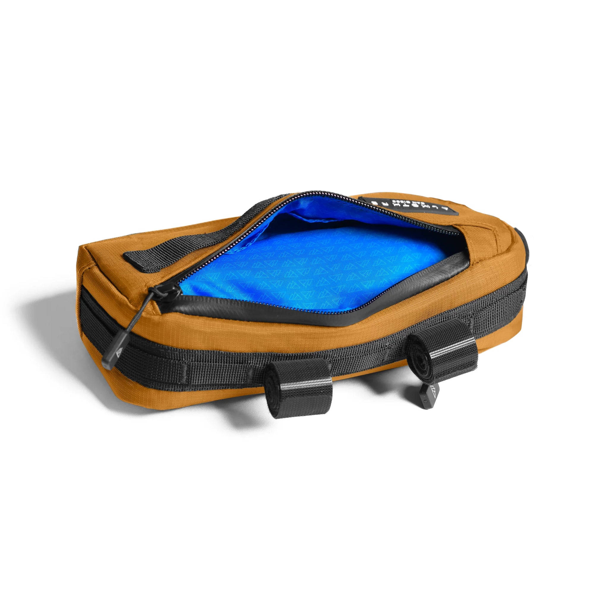 ALMSTHRE Compact Frame Bag in tan with open zipper showing bright blue interior and mounting straps on white background