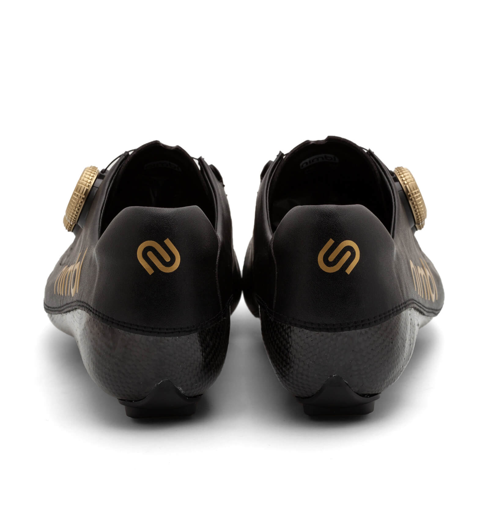 Back view of black Nimbl ULTIMATE cycling shoes with gold logo and fastening dial on a white background