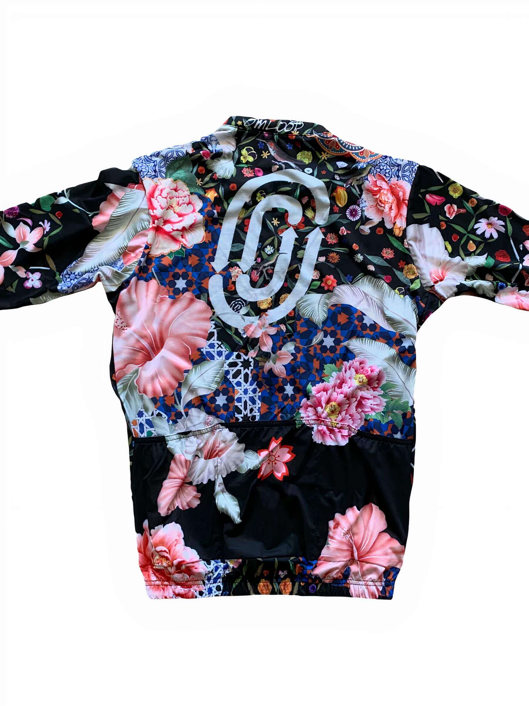 Back view of Ostroy Omloop Jersey - Women's featuring vibrant floral and geometric patterns with logo detail on black background