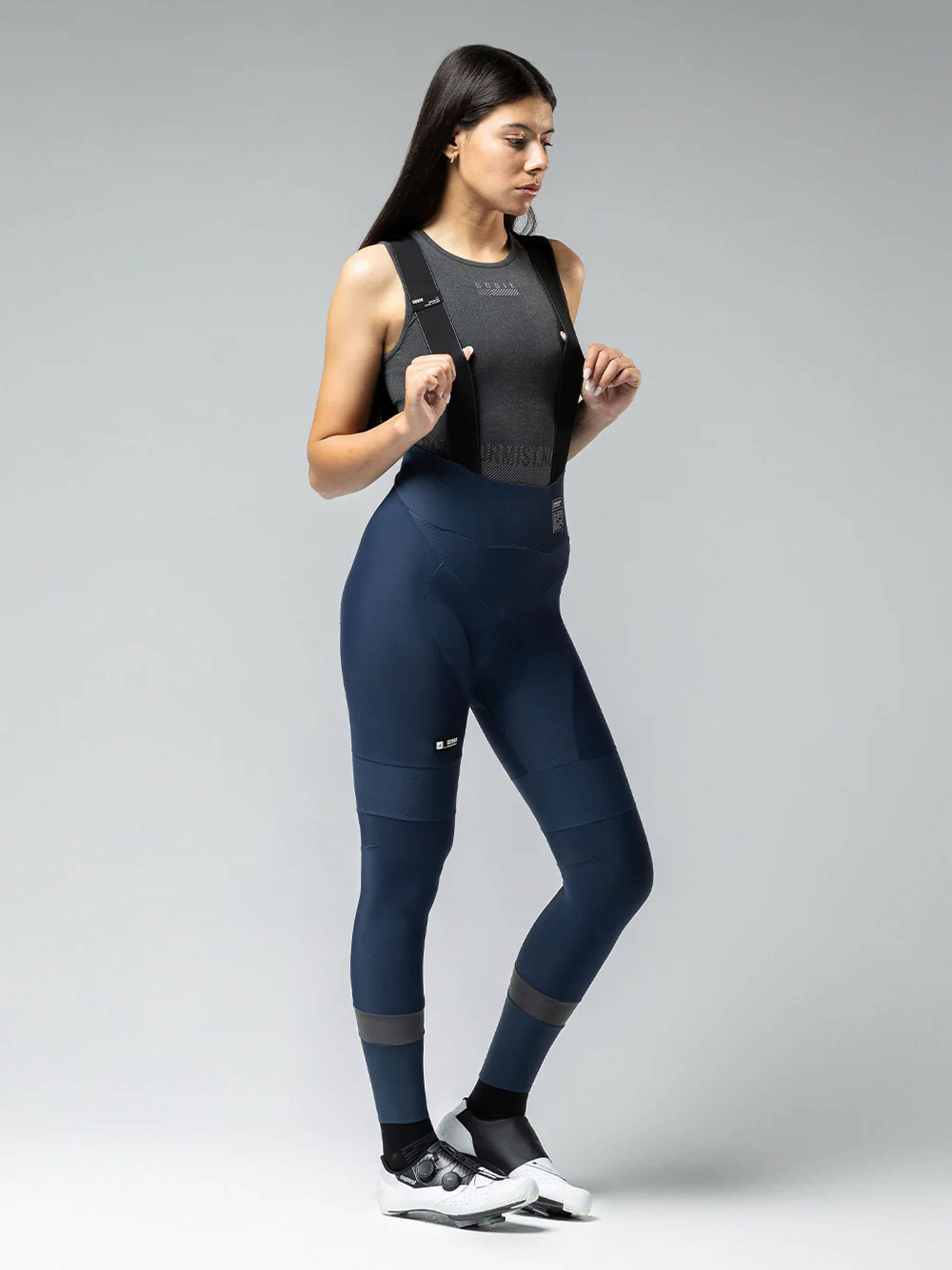 Woman wearing GOBIK Absolute 6.0 K9 Bib Tights - Women's in navy with supportive bib straps and sleek fit for cycling performance
